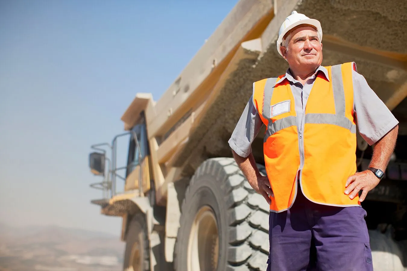 Man wearing HiVis Vest Safety Workwear doing field work for a manufacturing industry