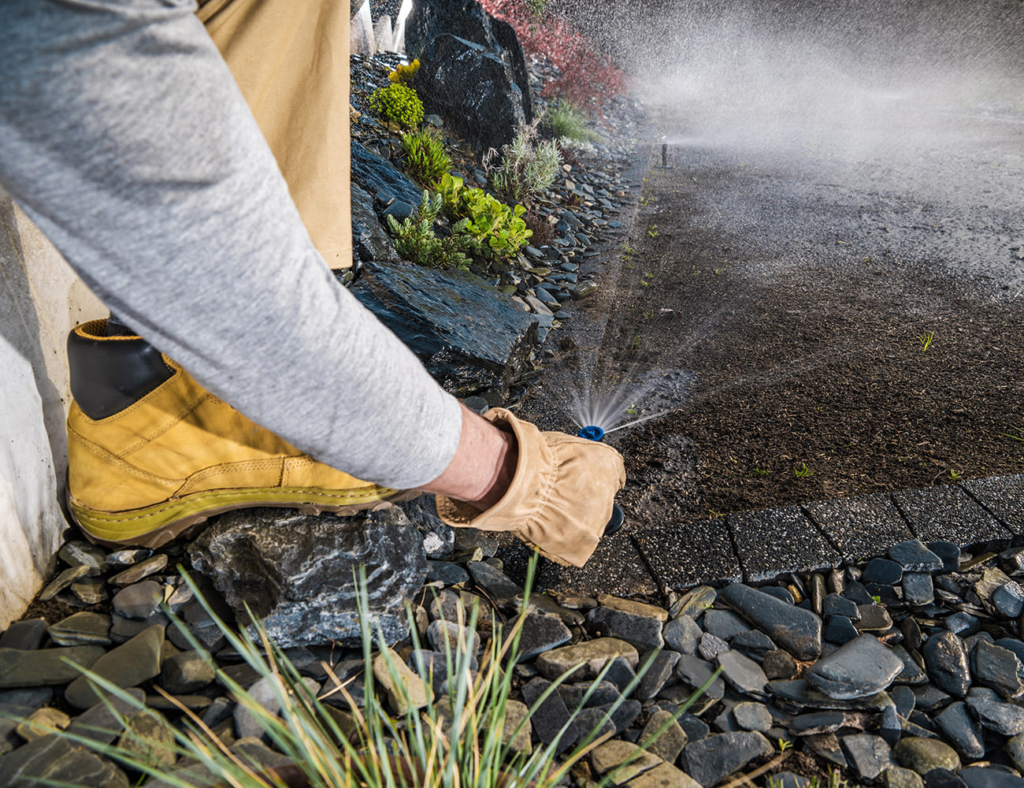 Lawn-Care-Tips-Adjusting-sprinklers-on-a-lawn