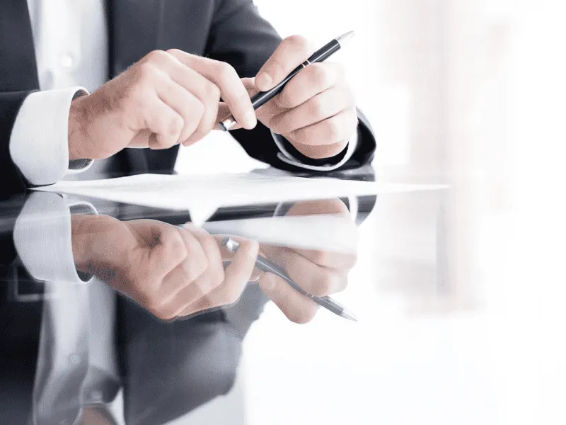 Man-reading-a comprehensive report to analyse historical data and external factors for smoother business operation