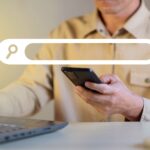 Search-Engine-Optimisation-Service-Man-searching-for-keywords-on-phone