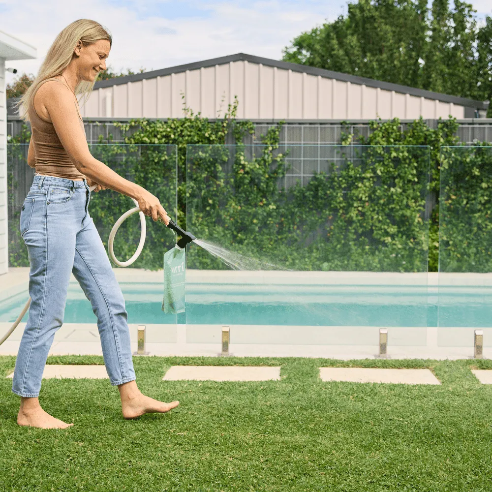 Eco-friendly-lawn-products-Woman-using-a-product-on-a-lawn