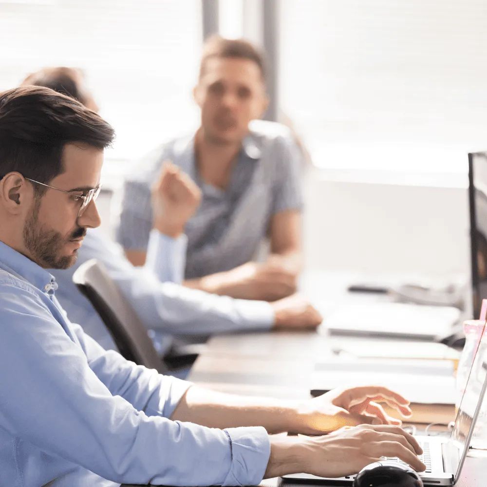 In-the-Trenches-podcast-Business-person-working-with-a-laptop