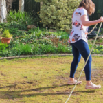 Woman working on spraying a warm weather lawn pests